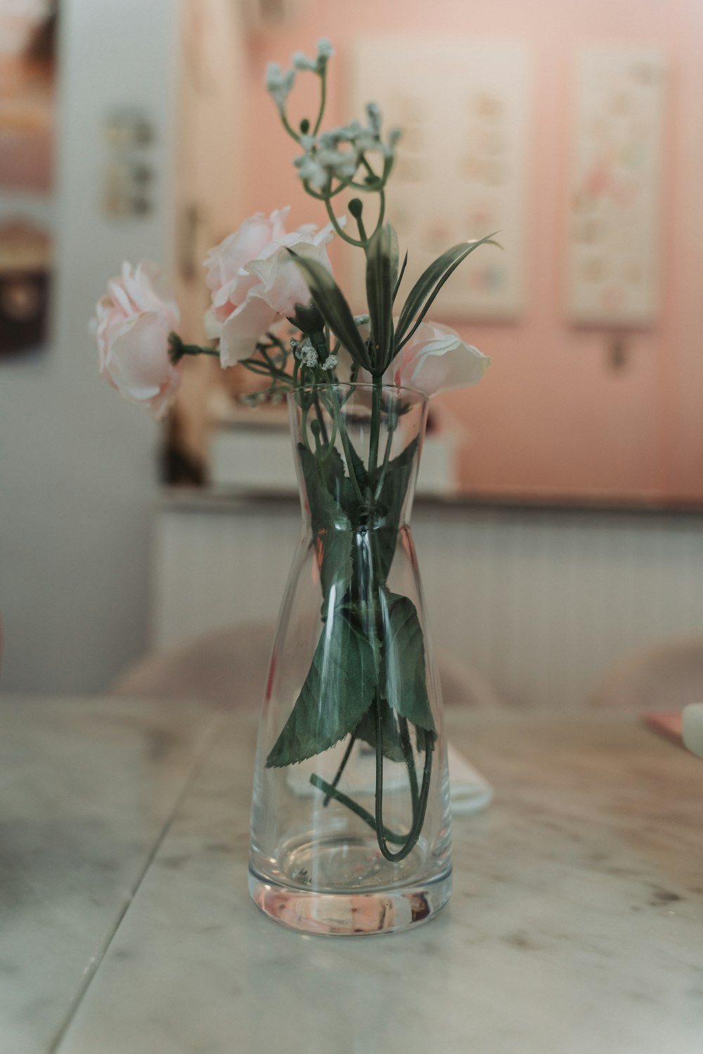 a glass vase filled with flowers on top of a table