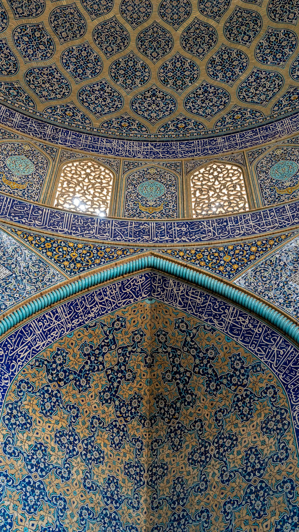 the ceiling of a building with blue and gold tiles