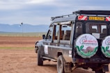 a vehicle parked on a dirt road in the middle of nowhere