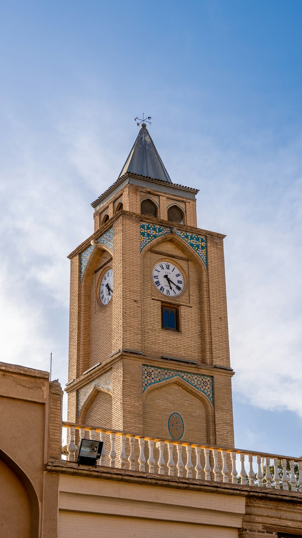 a tall clock tower with a clock on each of it's sides