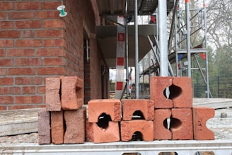 a pile of bricks sitting in front of a building