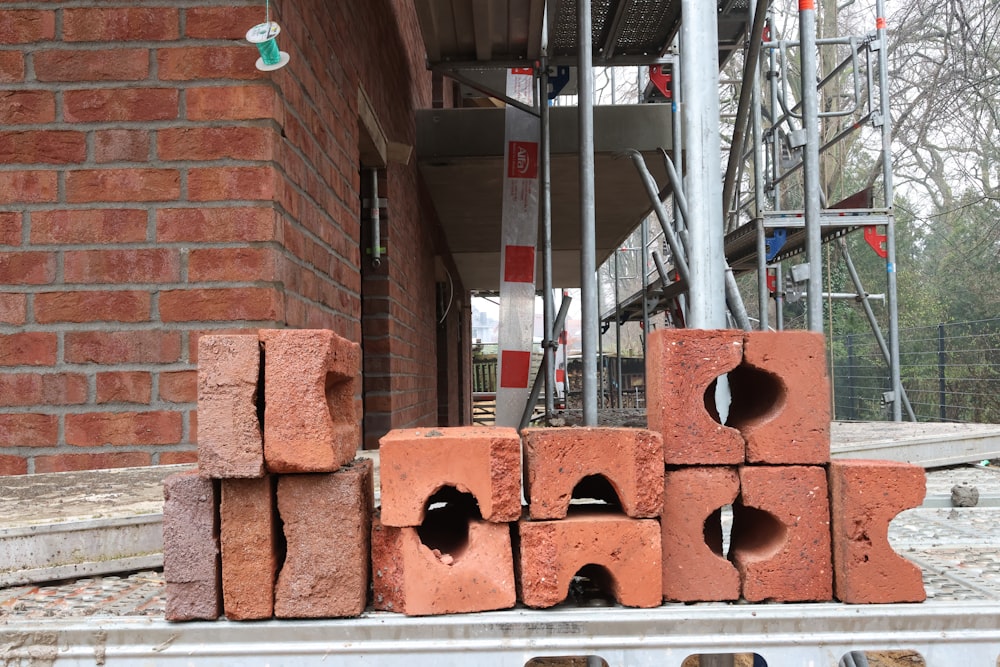 a pile of bricks sitting in front of a building