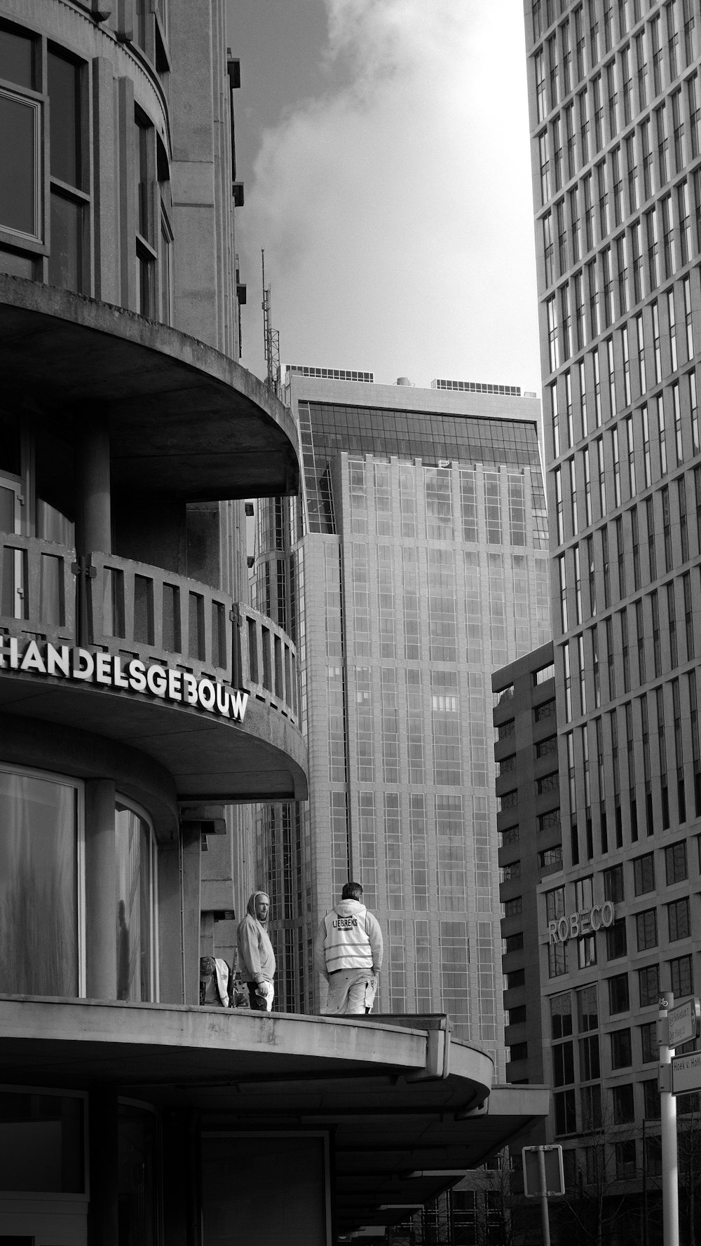 a couple of people sitting on a balcony of a building