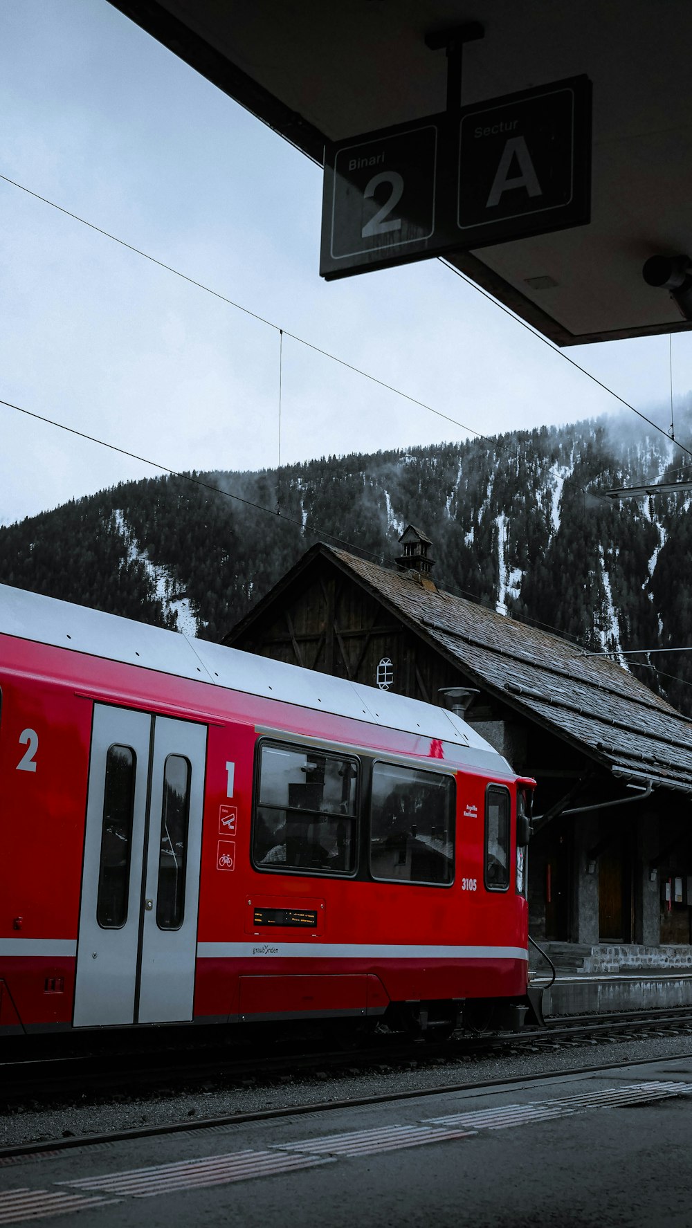 a red and white train at a train station