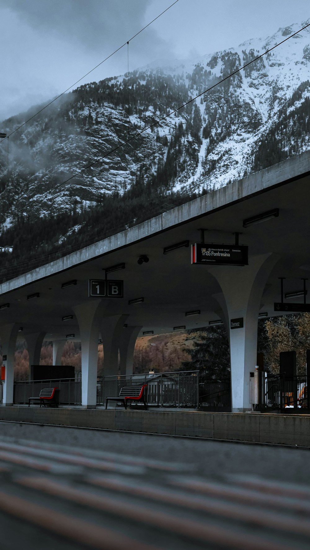 a train station with a mountain in the background