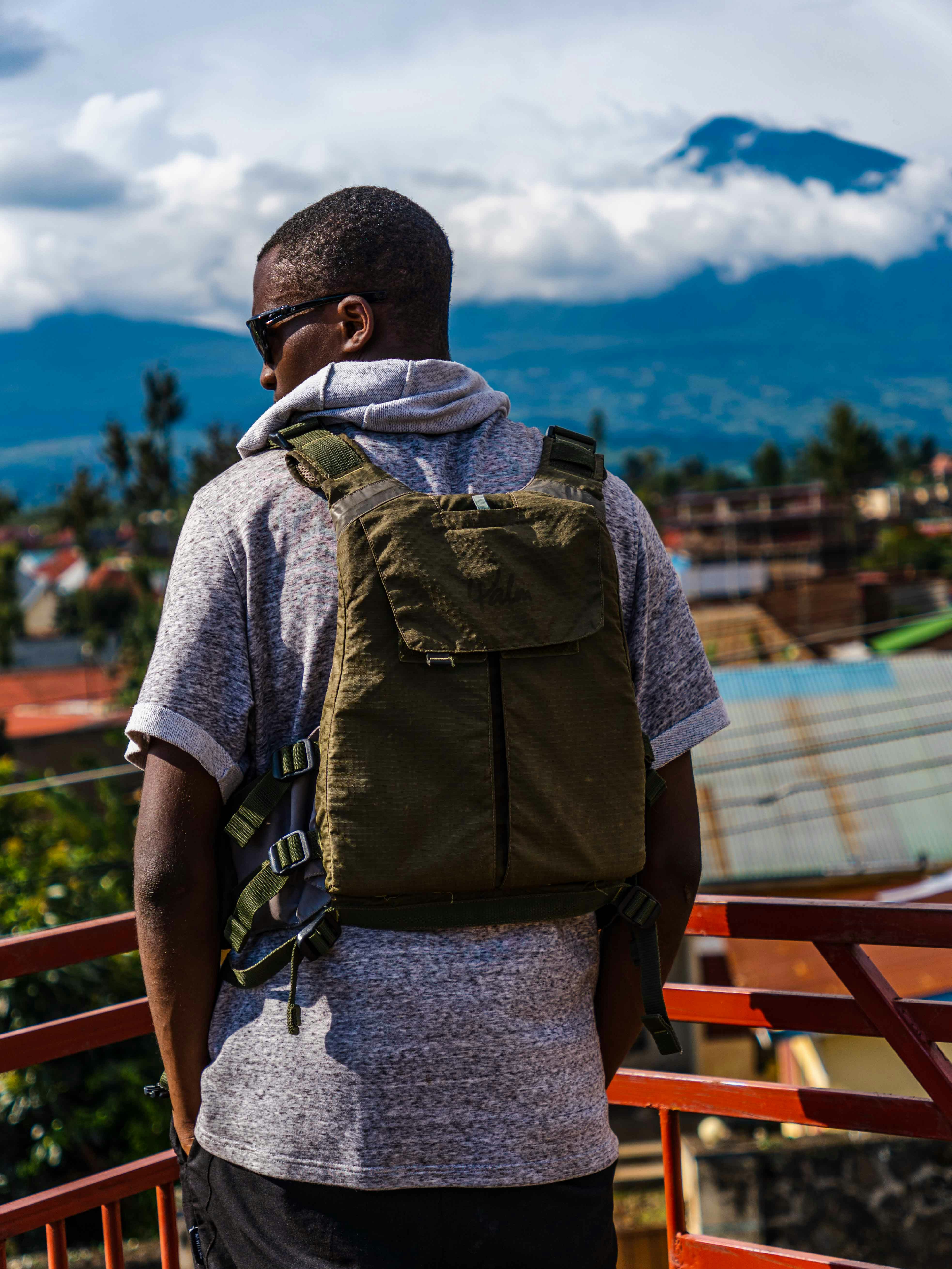 a man with a backpack standing on a balcony