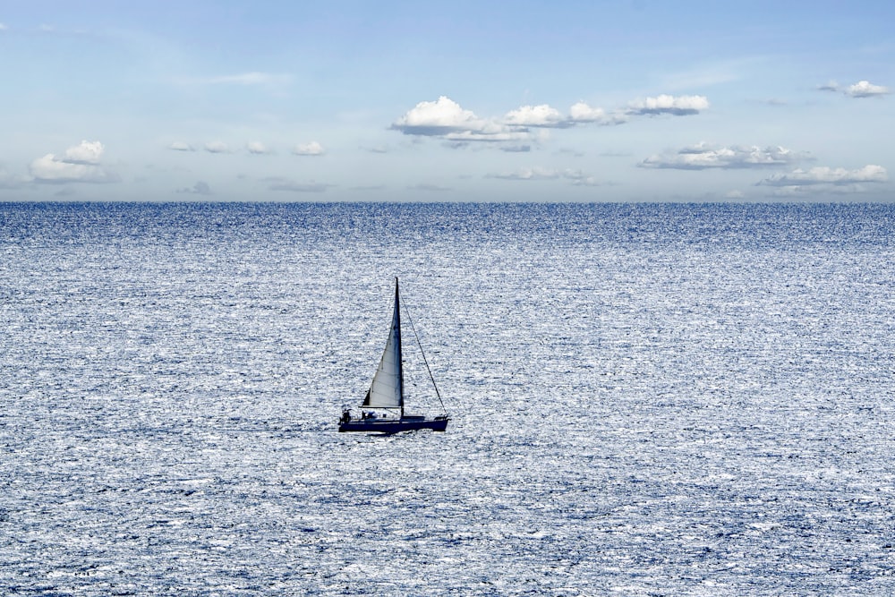 a sailboat in the middle of the ocean