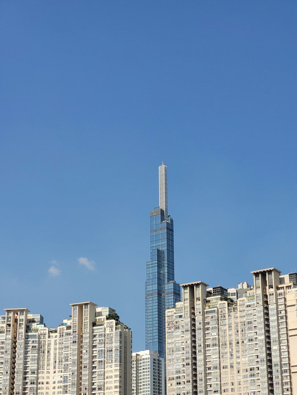 a tall building towering over a city filled with tall buildings