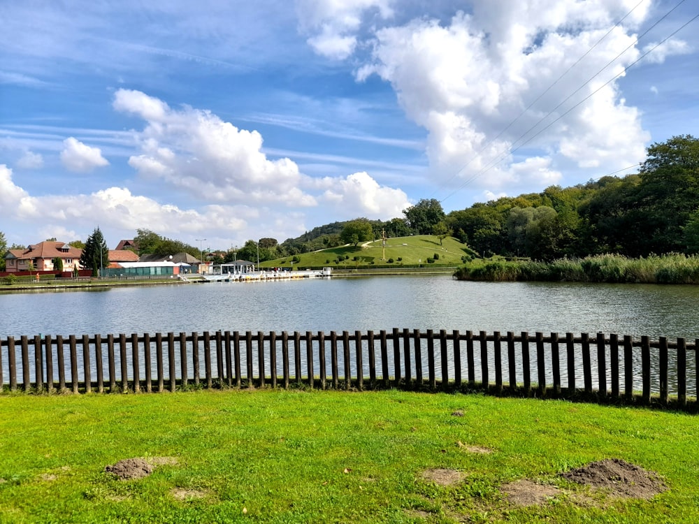 a view of a body of water with houses in the background