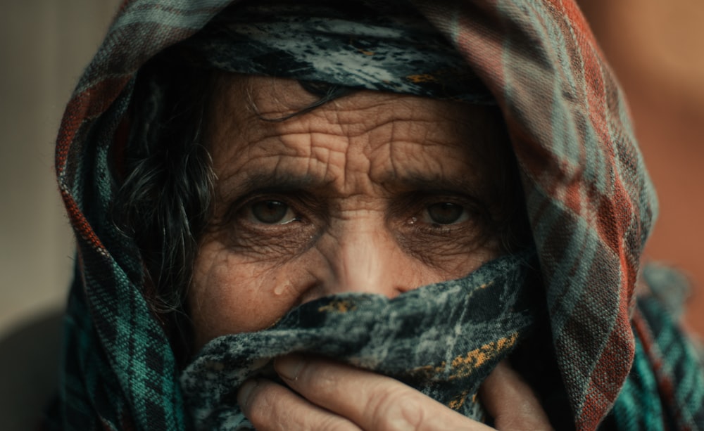 a close up of a person wearing a scarf