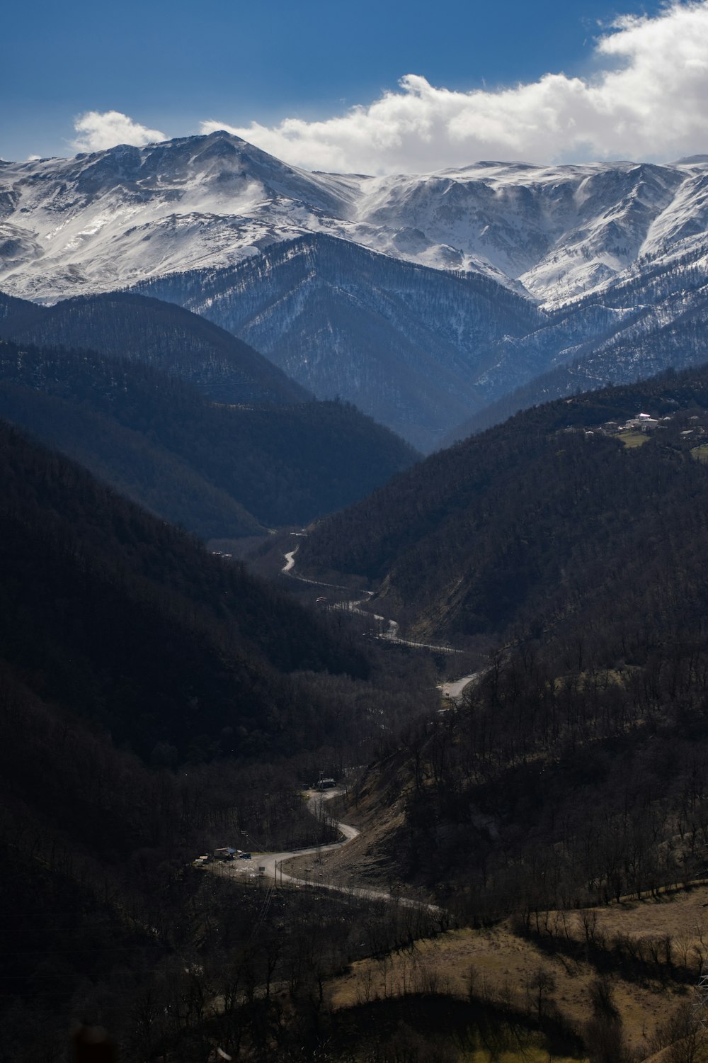 a view of a valley with mountains in the background