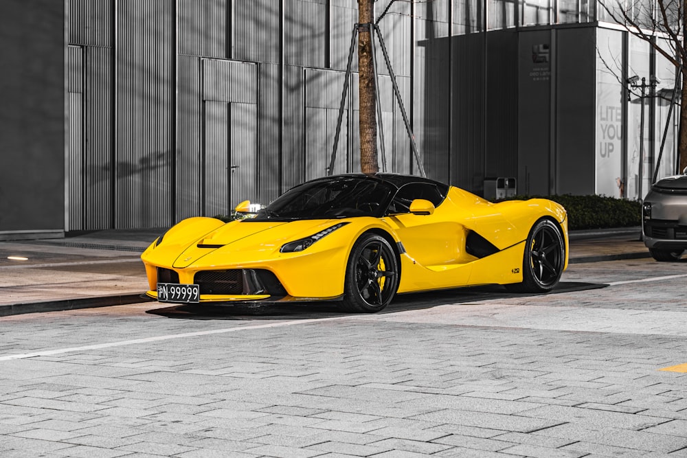 a yellow sports car parked in front of a building