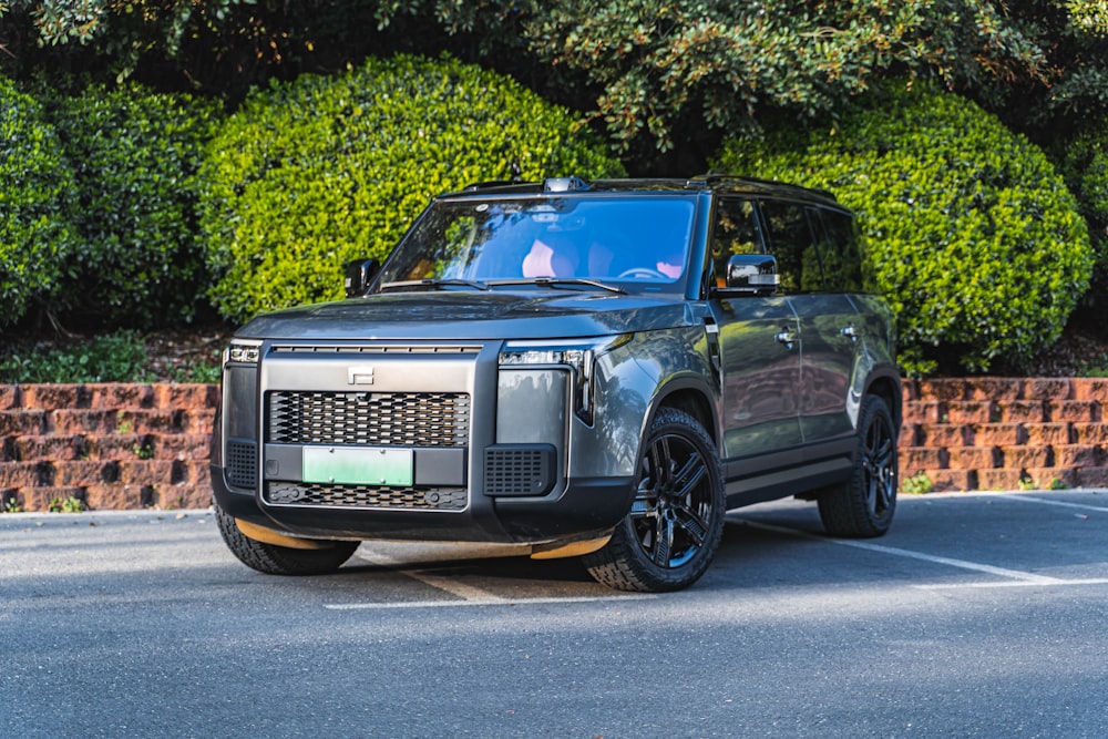 a black land rover parked in a parking lot