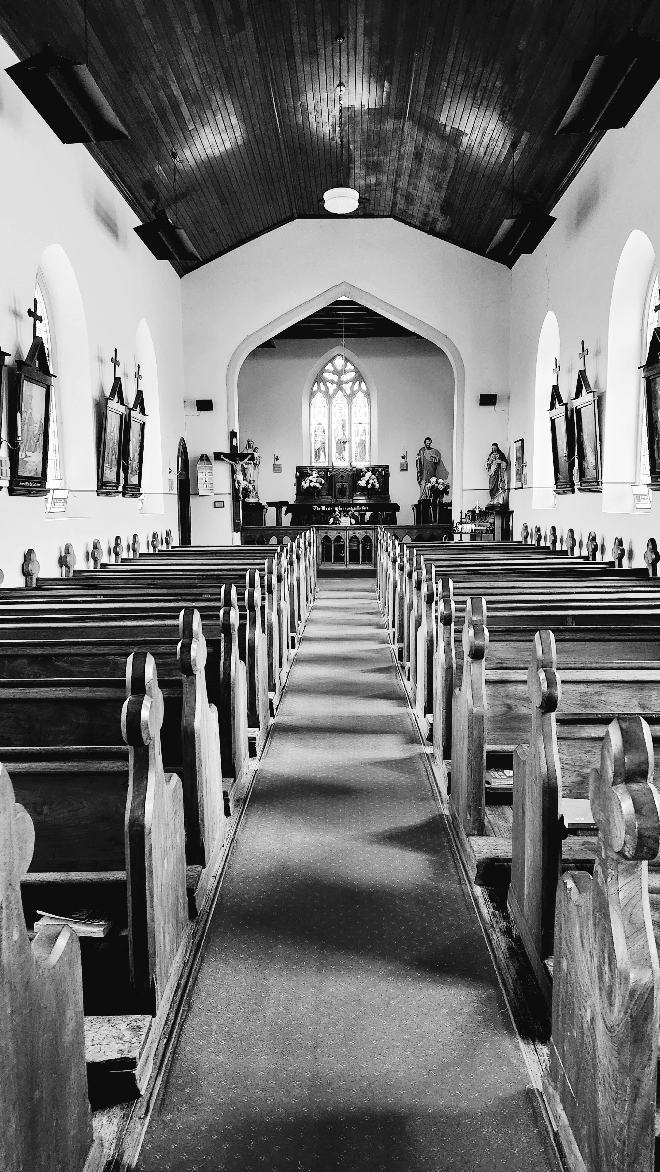 a black and white photo of a church with pews