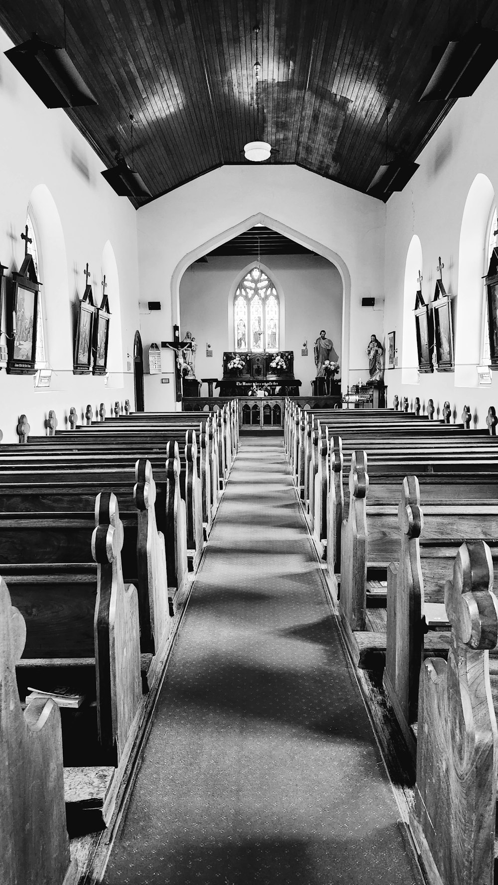 a black and white photo of a church with pews