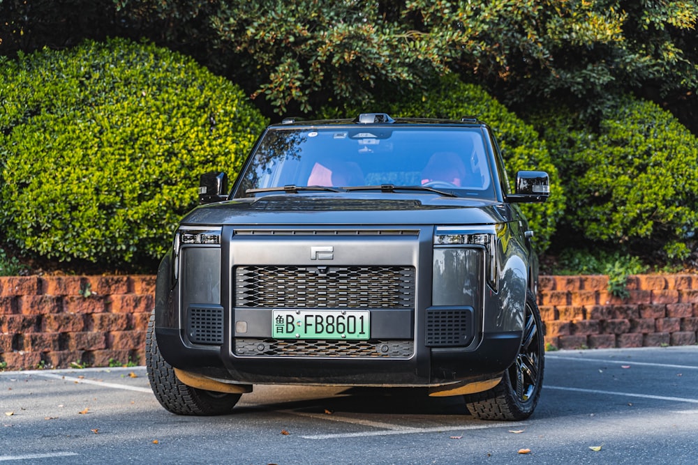 a black land rover parked in a parking lot