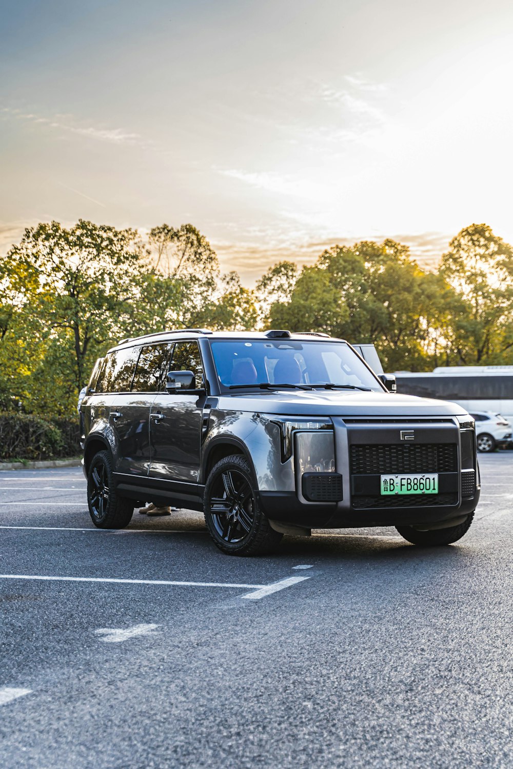 a black suv is parked in a parking lot