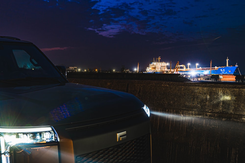 a truck parked on the side of a road at night