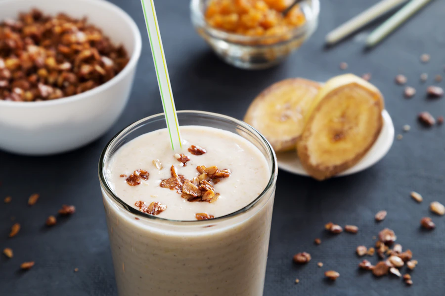 Creamy shake in a glass with a straw