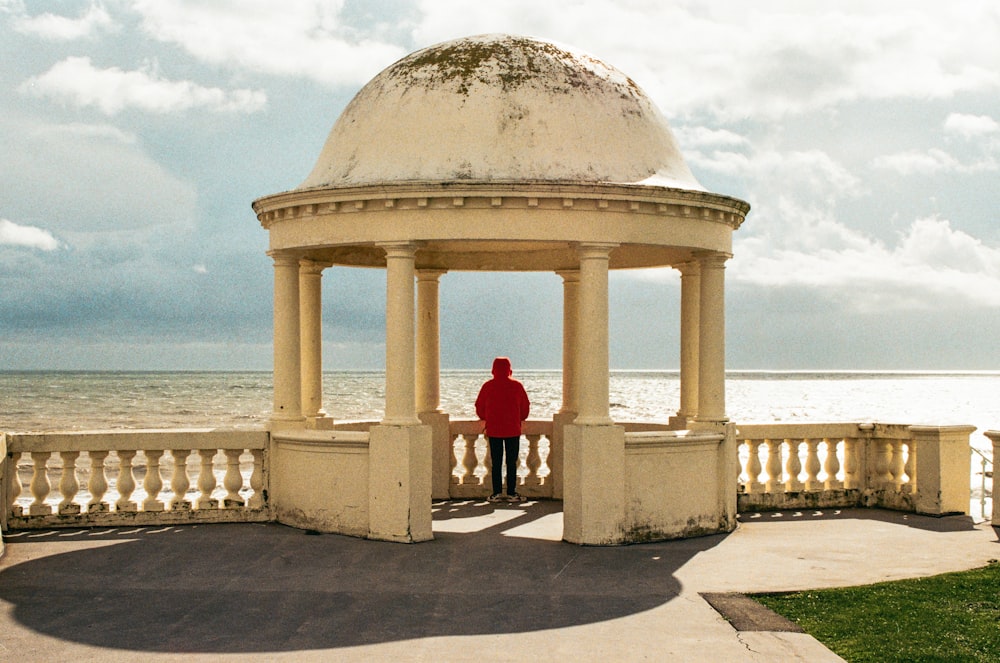 a man standing in front of a white gazebo