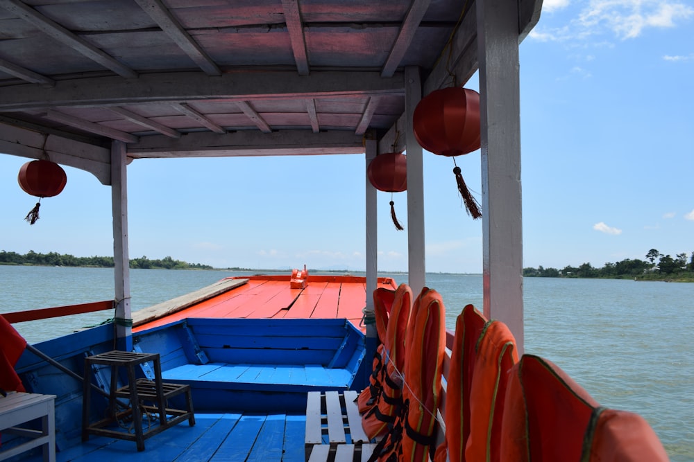 a blue and red boat on a body of water