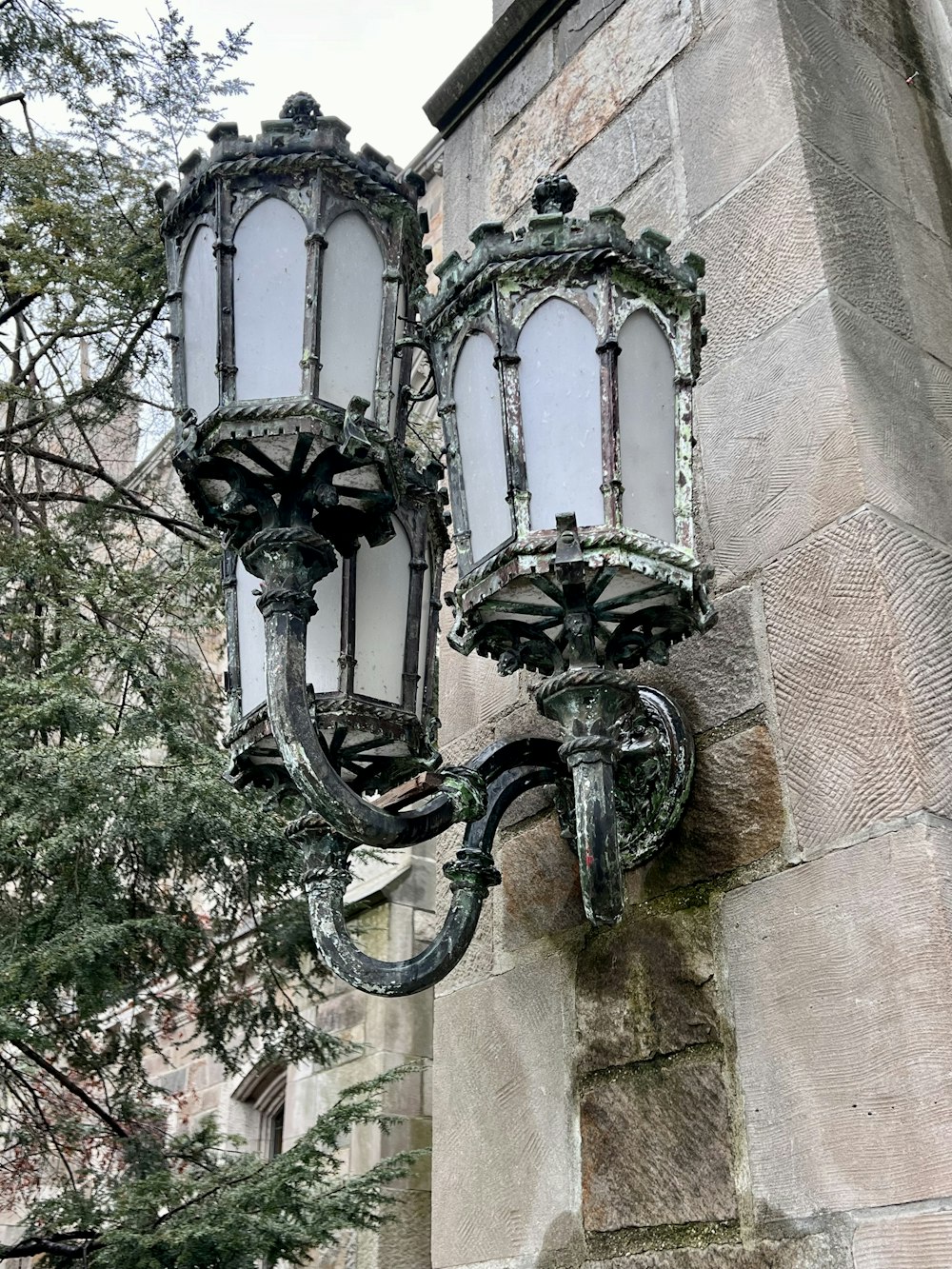 a couple of street lights sitting on the side of a building