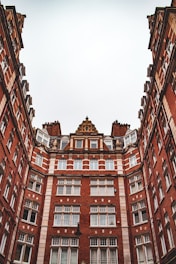 a tall red brick building with lots of windows