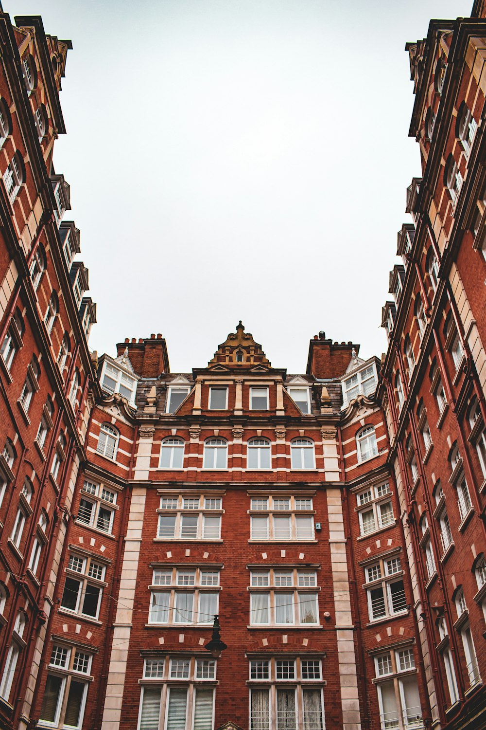 a tall red brick building with lots of windows