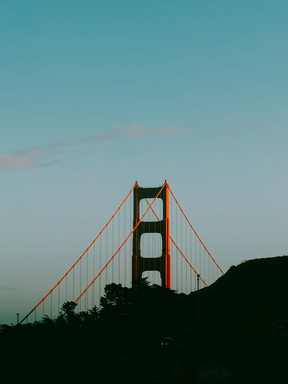 the golden gate bridge is silhouetted against a blue sky