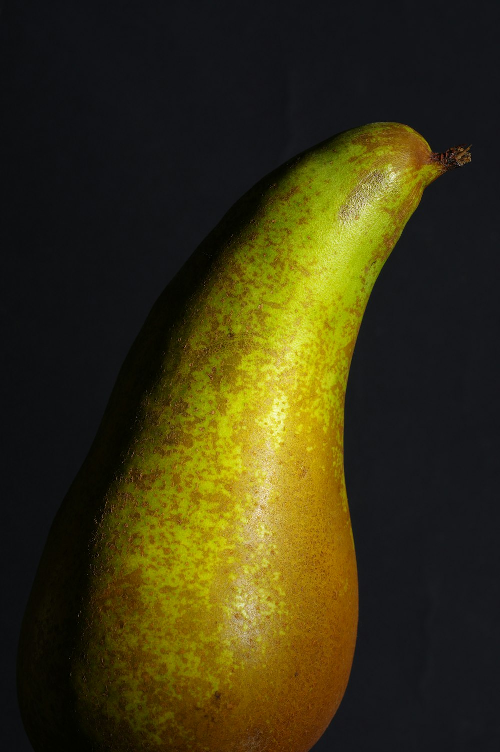 a close up of a pear on a black background