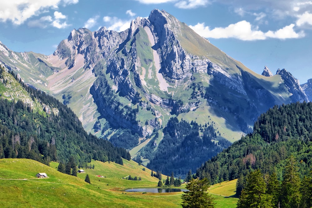 a mountain range with a lake in the foreground