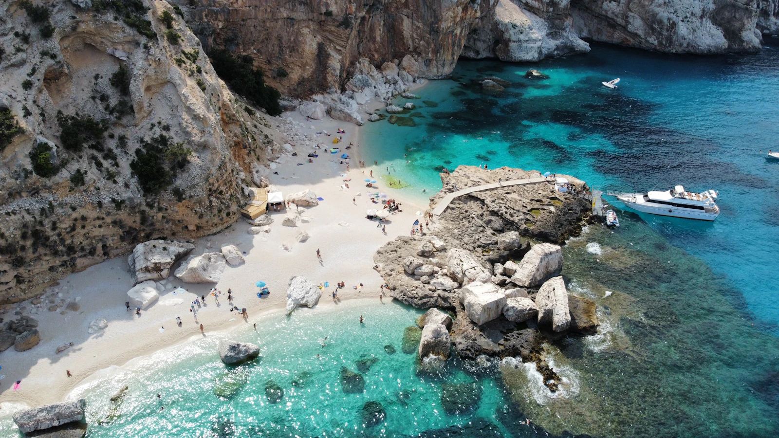 A cove on the Gulf of Orosei, white pebbles between limestone cliffs — Sardinia, Italy