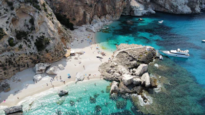 A cove on the Gulf of Orosei, white pebbles between limestone cliffs — Sardinia, Italy