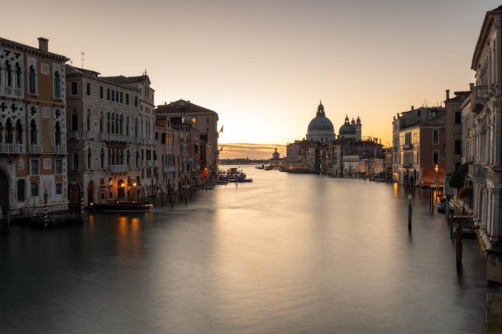 a river running through a city next to tall buildings