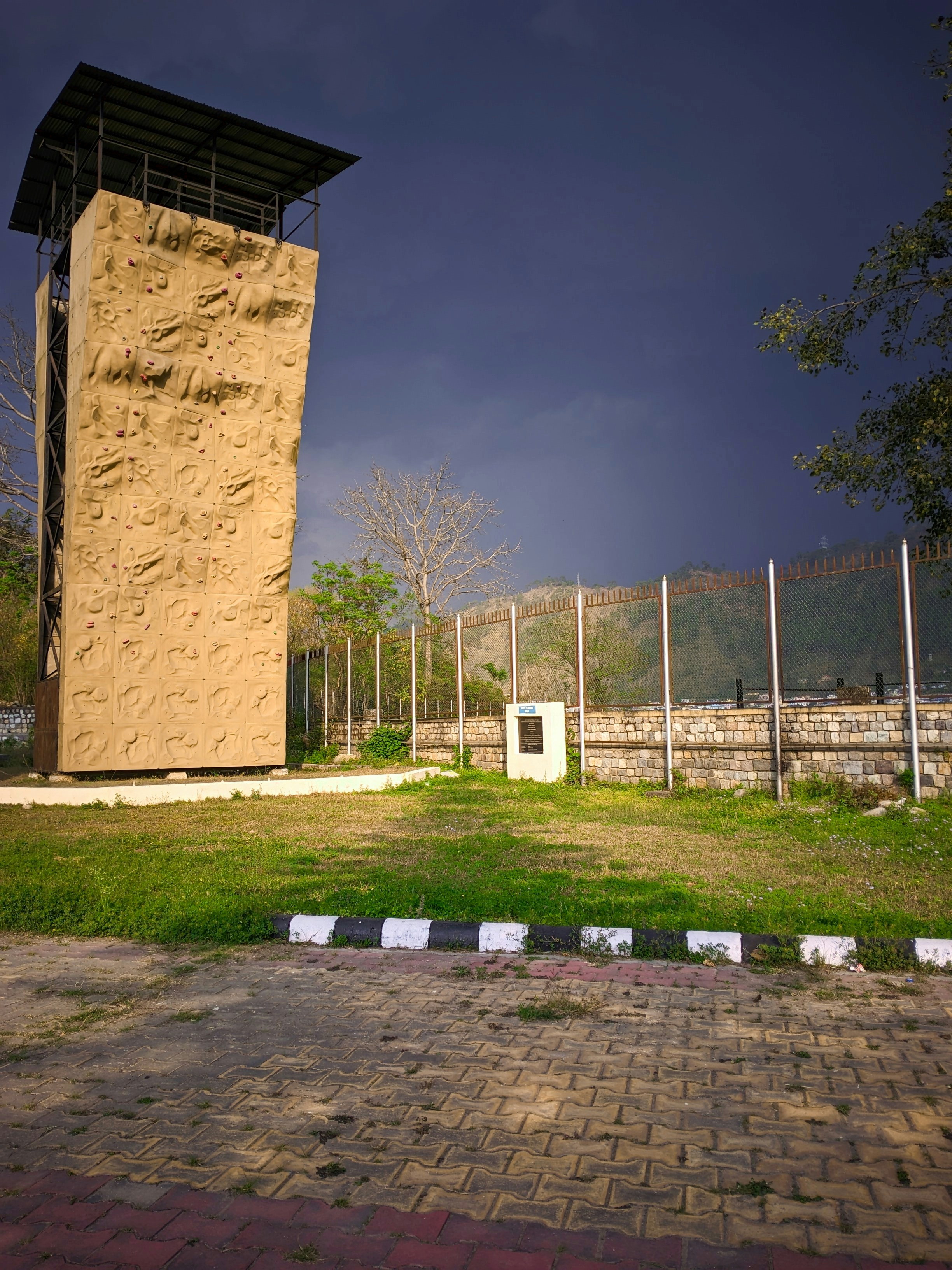 a tall building sitting on top of a lush green field