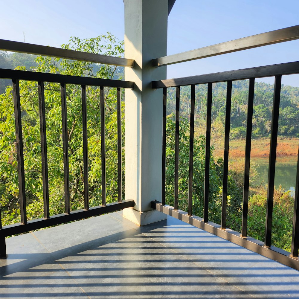 a balcony with a railing and a view of a river