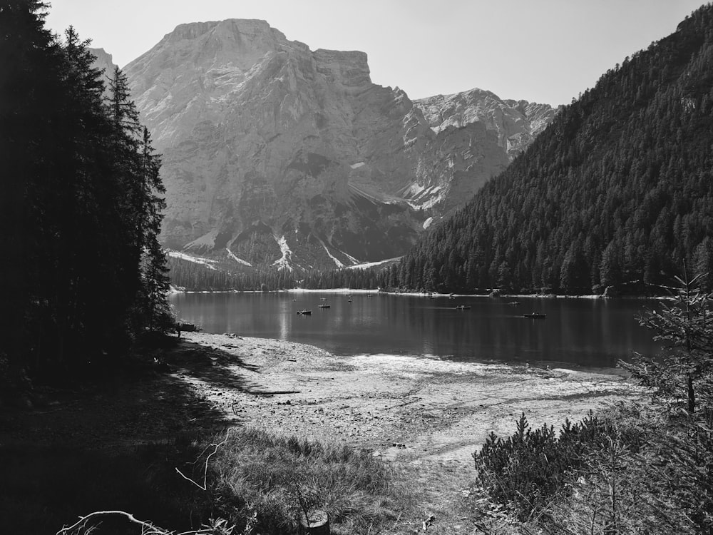 a black and white photo of a mountain lake