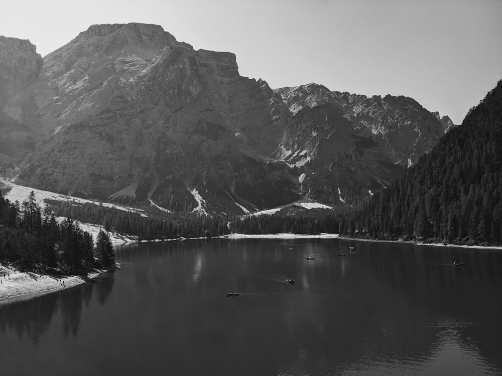 a black and white photo of a mountain lake