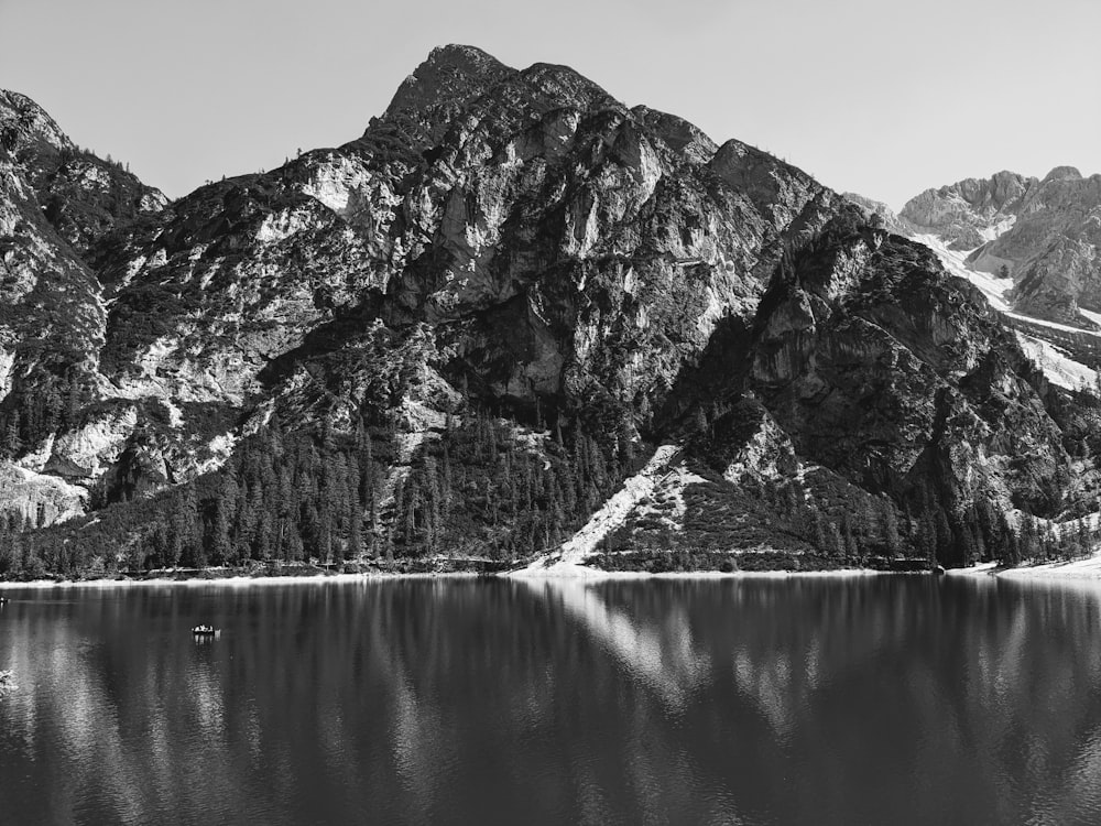 a black and white photo of a mountain lake
