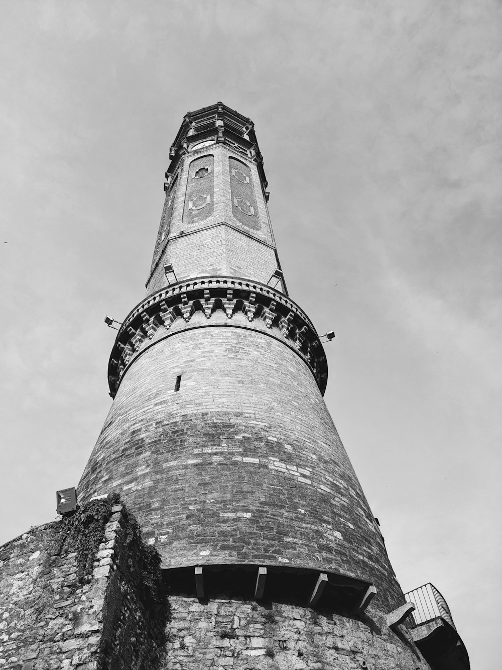 a black and white photo of a tall tower