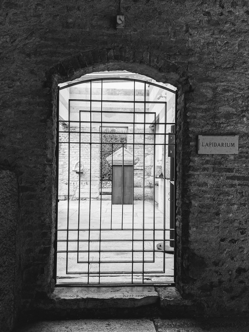 a black and white photo of a jail cell