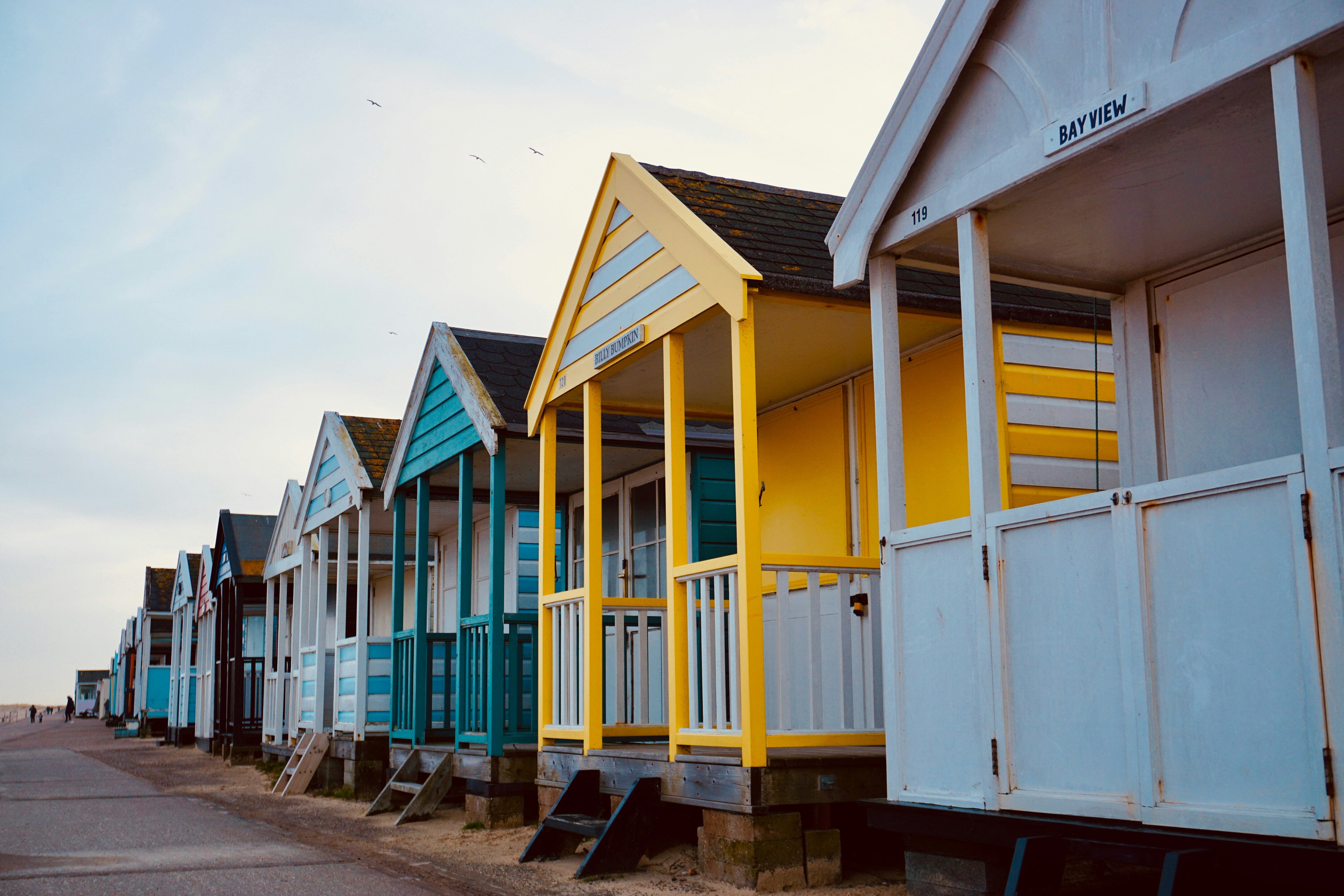 a row of colorful beach huts sitting next to each other