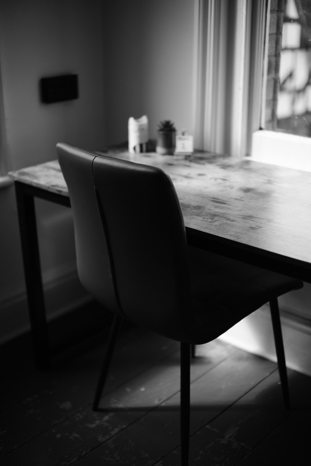 a black and white photo of a dining table