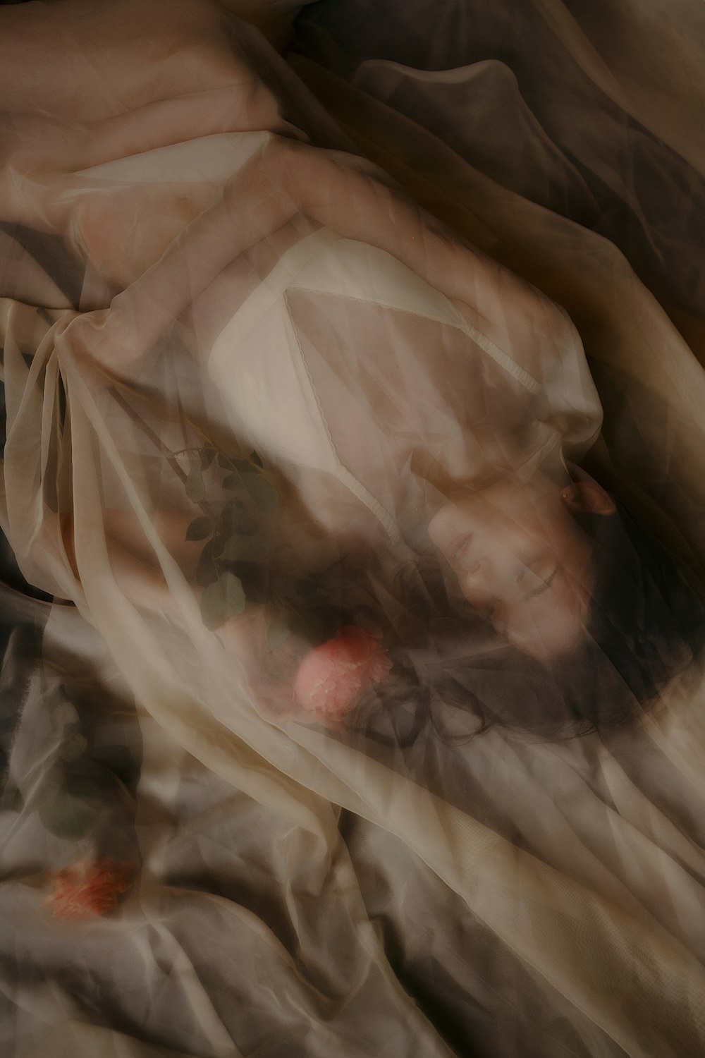 a blurry image of a woman laying on a bed