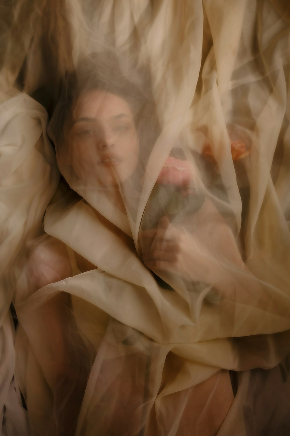 a blurry photo of a woman wrapped in a blanket