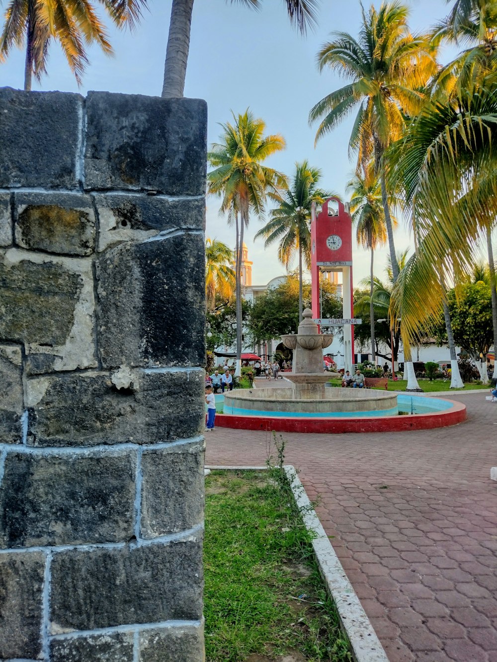 a clock tower in the middle of a park