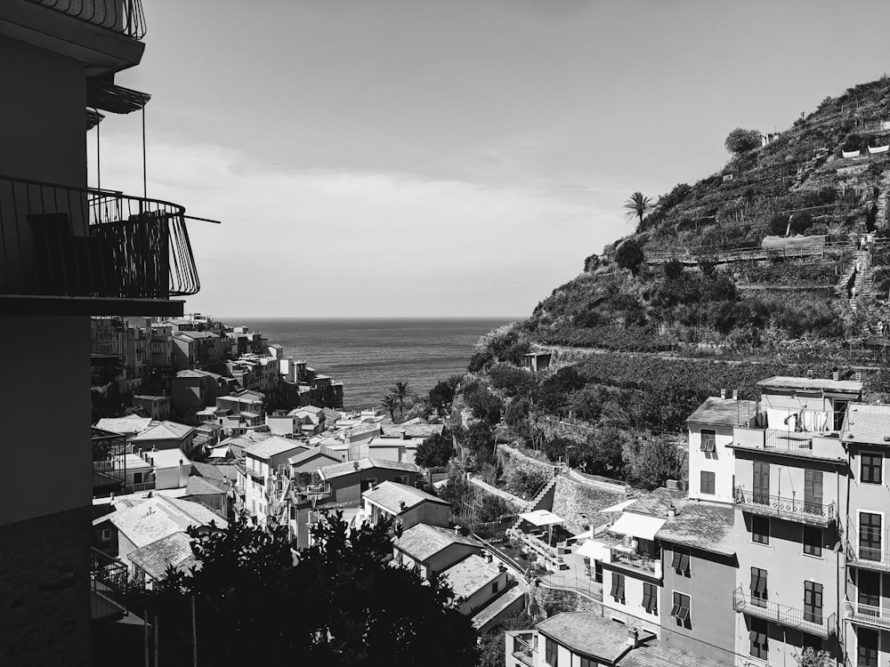 a black and white photo of a town by the ocean