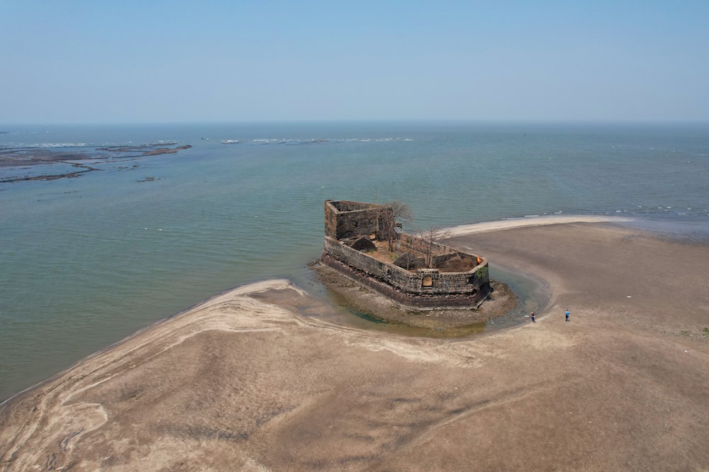 an aerial view of a castle on an island in the middle of the ocean