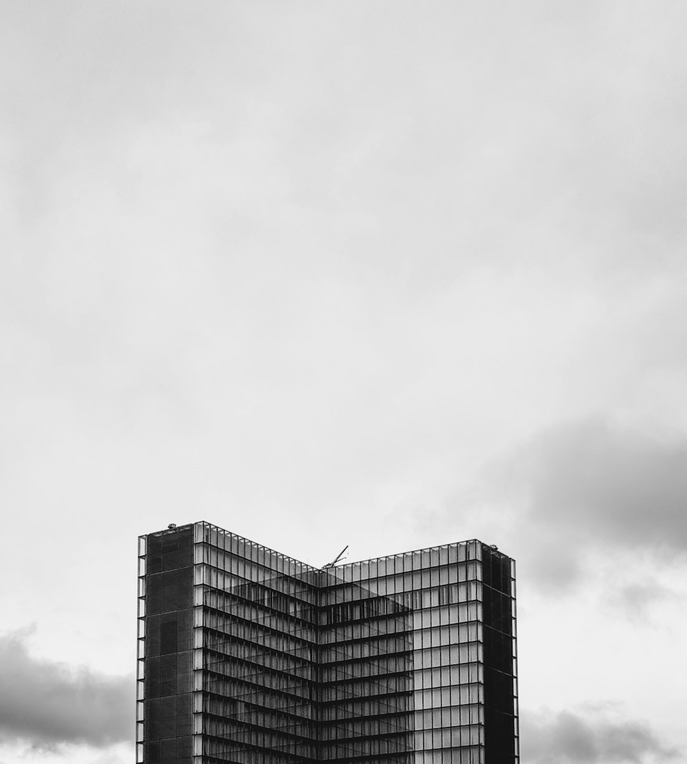 a very tall building sitting in the middle of a field