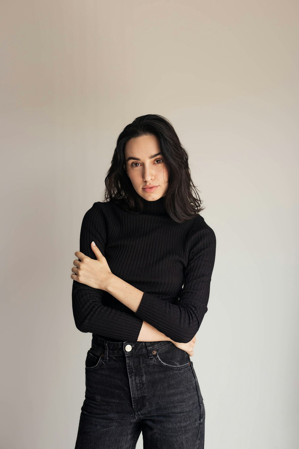 a woman wearing a black turtle neck sweater